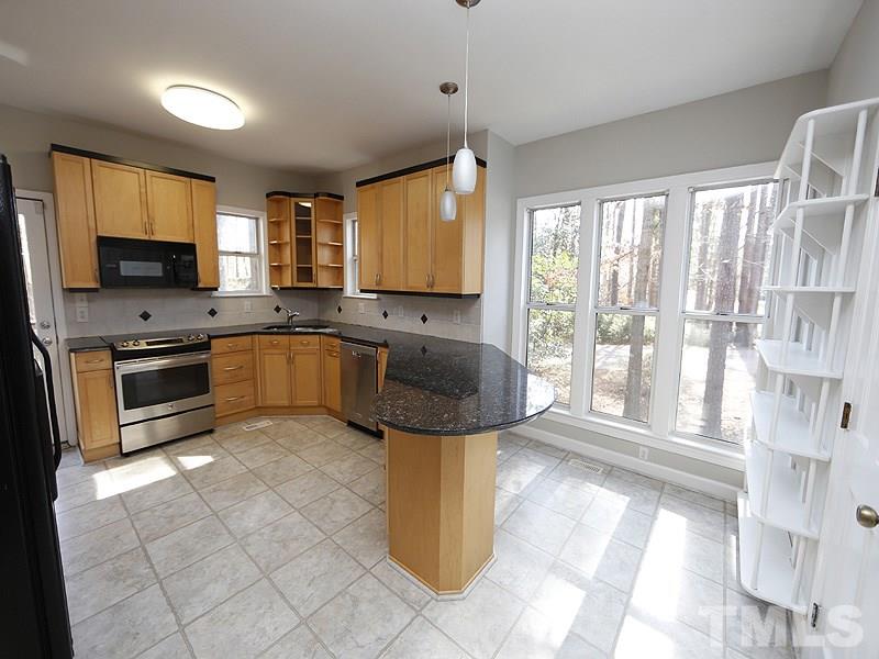 5919 Sentinel Drive Raleigh, NC 27609 - Photo 4 of 13 a kitchen with a sink a counter top space appliances and cabinets
