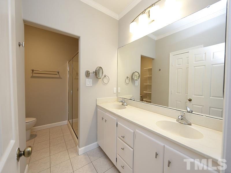5919 Sentinel Drive Raleigh, NC 27609 - Photo 7 of 13 a bathroom with a sink a toilet and a mirror