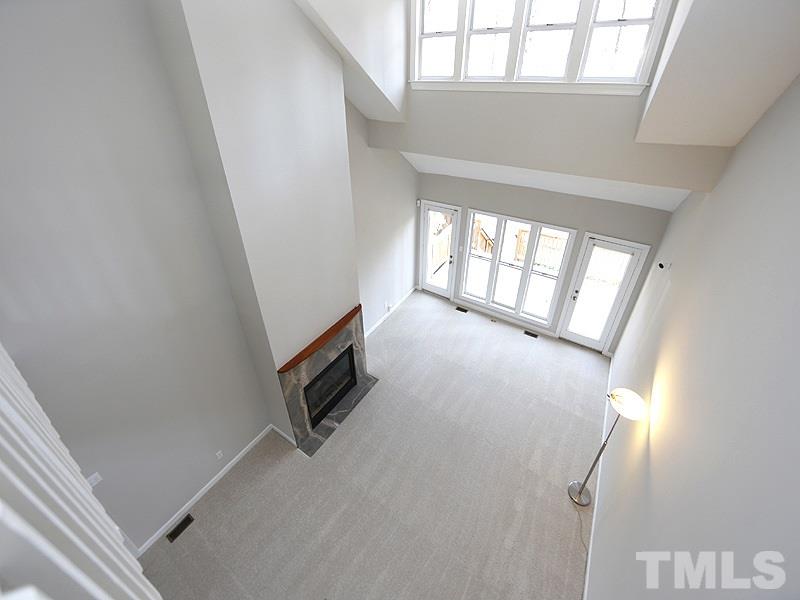 5919 Sentinel Drive Raleigh, NC 27609 - Photo 9 of 13 a view of an empty room with wooden floor and a window