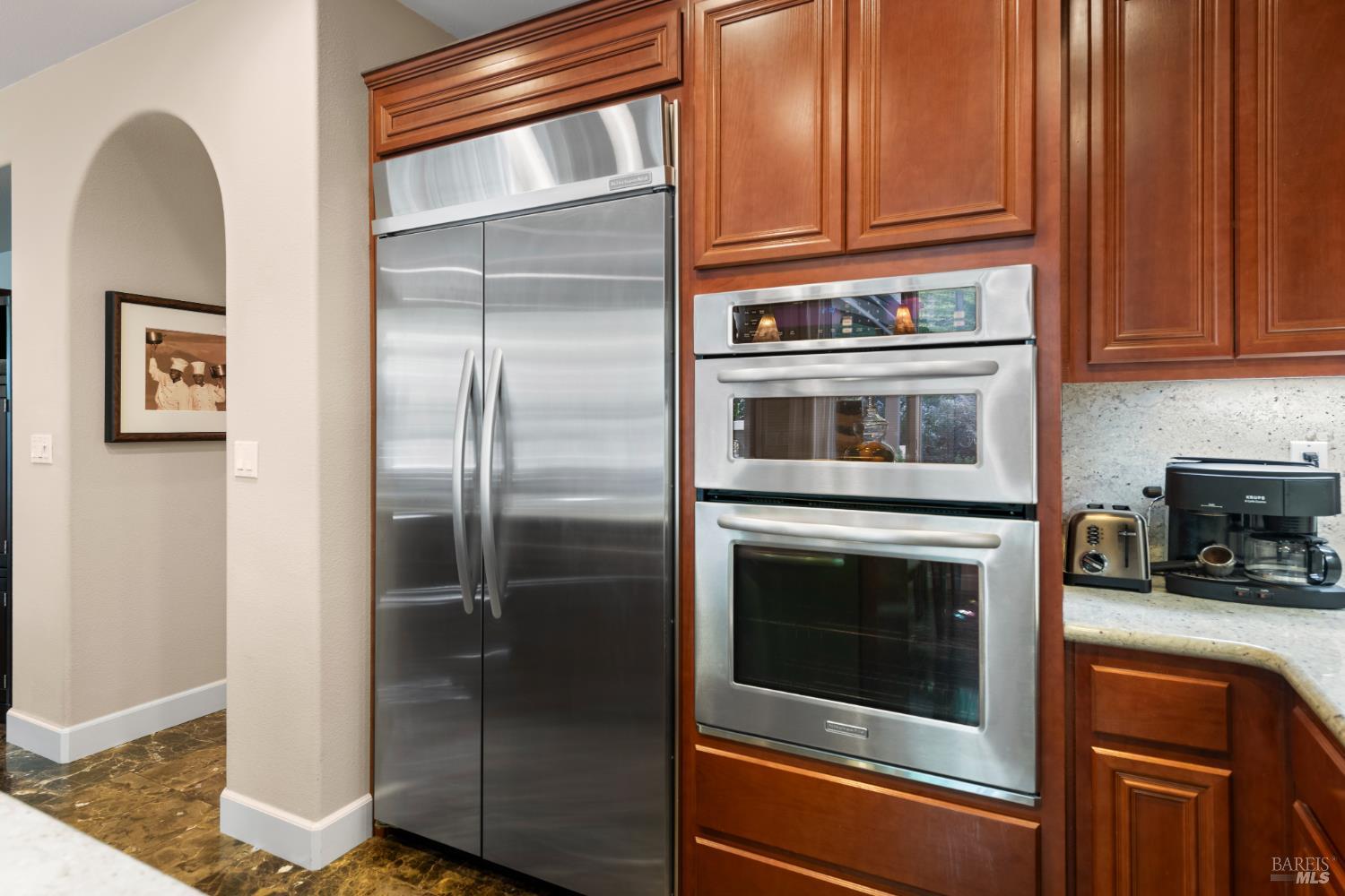 3183 Olympic Road Fairfield, CA 94534 - Photo 51 of 69 a kitchen with granite countertop stainless steel appliances and wooden cabinets