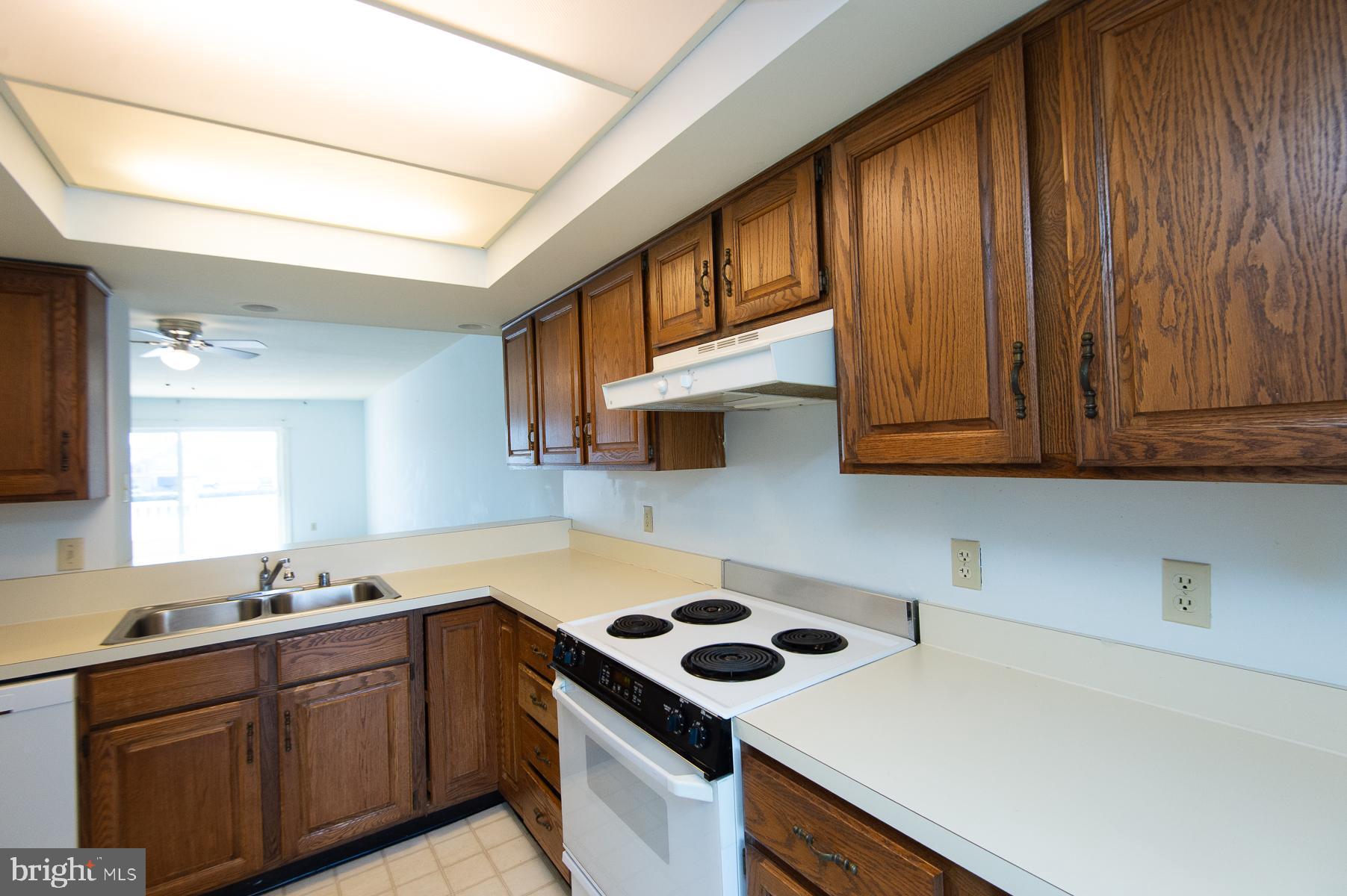 204 Market Square, Unit 12C Cambridge, MD 21613 - Photo 14 of 44 a kitchen with a sink cabinets and appliances