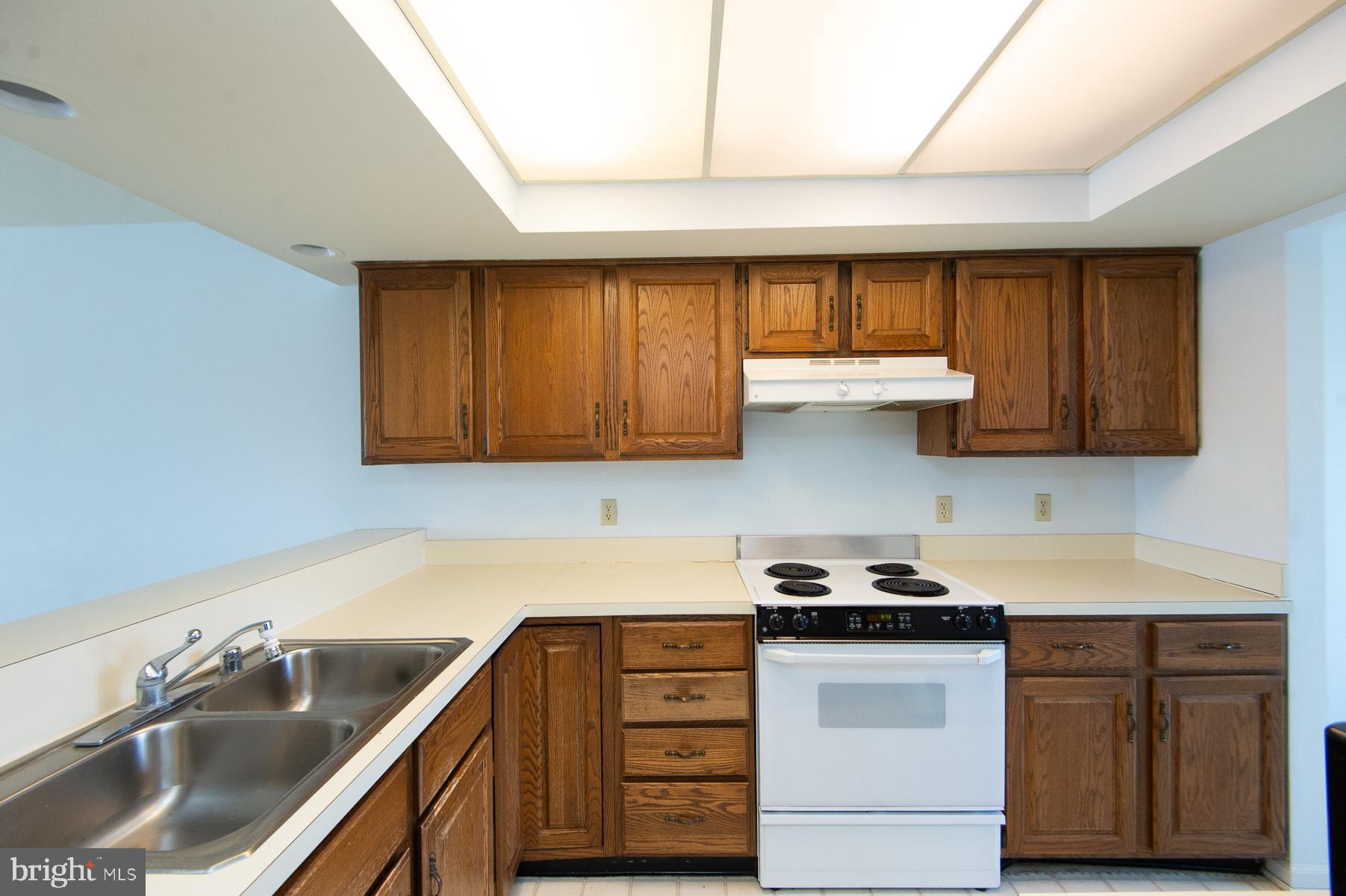 204 Market Square, Unit 12C Cambridge, MD 21613 - Photo 15 of 44 a kitchen with stainless steel appliances granite countertop a sink stove and cabinets