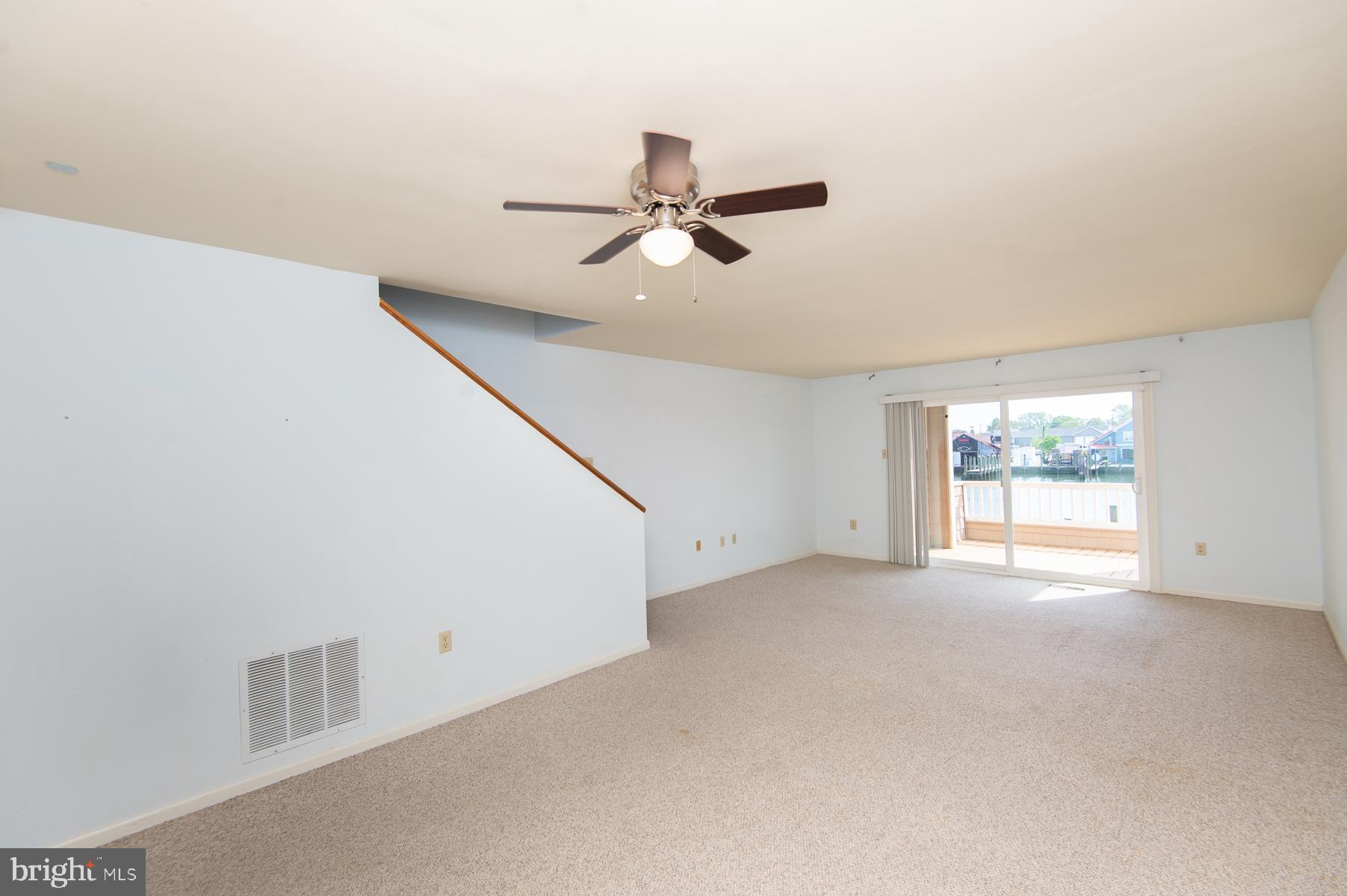 204 Market Square, Unit 12C Cambridge, MD 21613 - Photo 18 of 44 an empty room with windows and fan