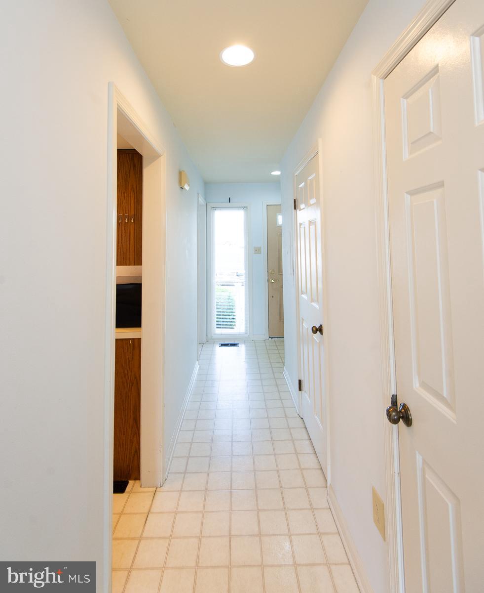 204 Market Square, Unit 12C Cambridge, MD 21613 - Photo 22 of 44 a view of a hallway with wooden floor and staircase