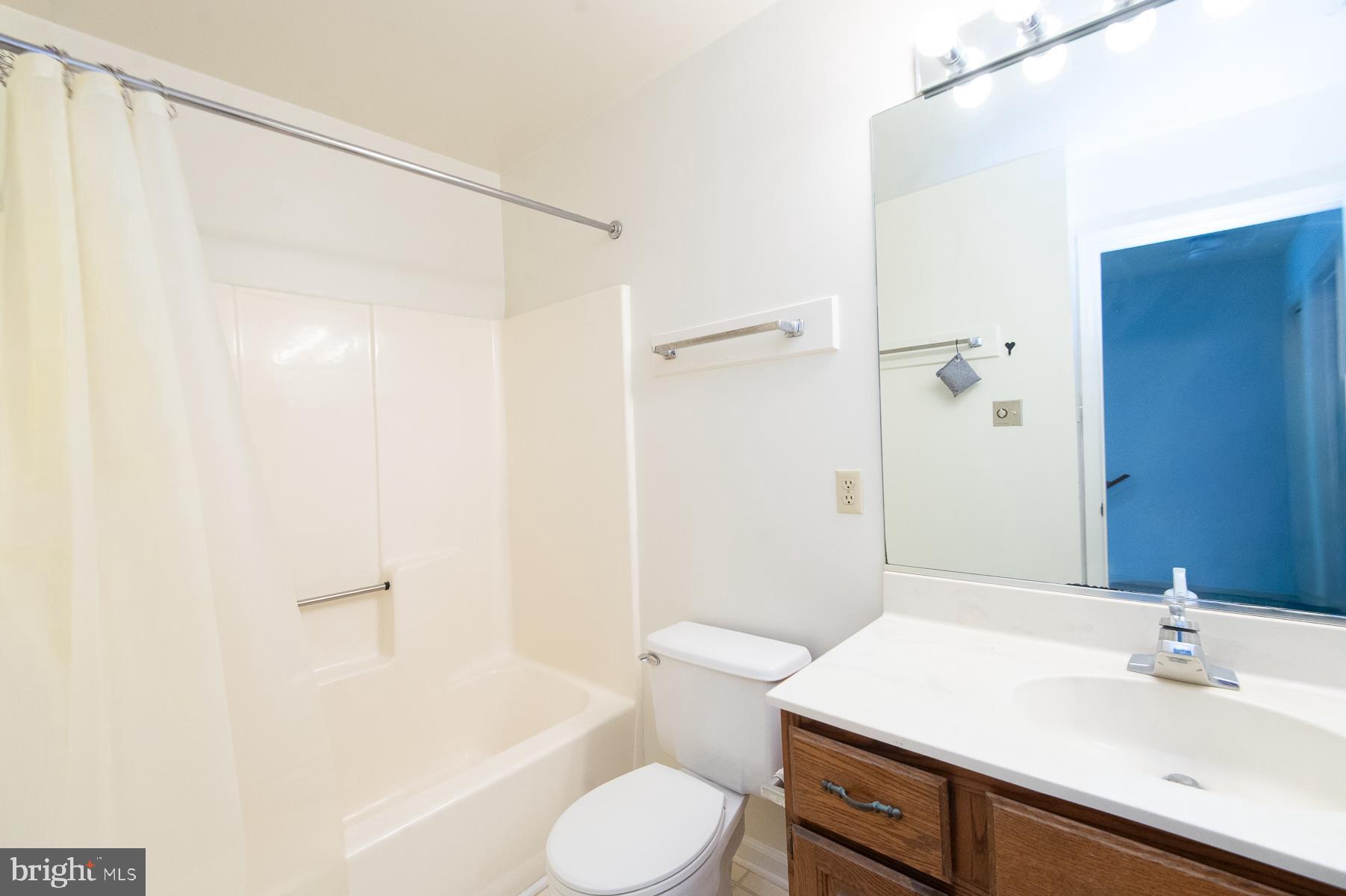 204 Market Square, Unit 12C Cambridge, MD 21613 - Photo 26 of 44 a bathroom with a sink toilet and shower