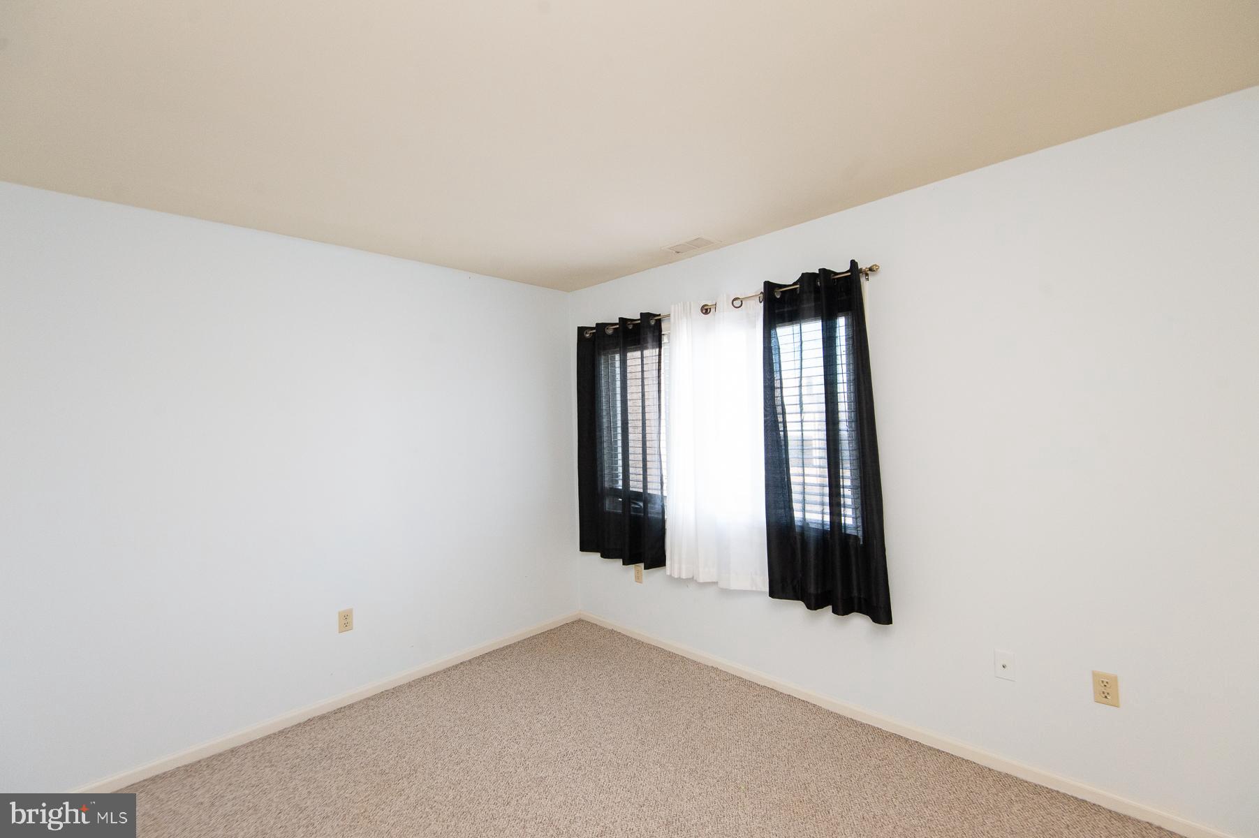 204 Market Square, Unit 12C Cambridge, MD 21613 - Photo 27 of 44 an empty room with windows