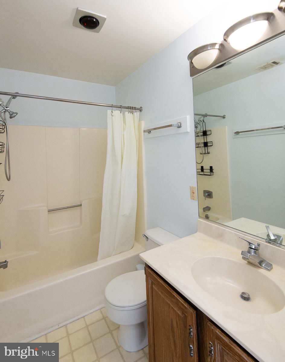 204 Market Square, Unit 12C Cambridge, MD 21613 - Photo 35 of 44 a bathroom with a sink a toilet and shower