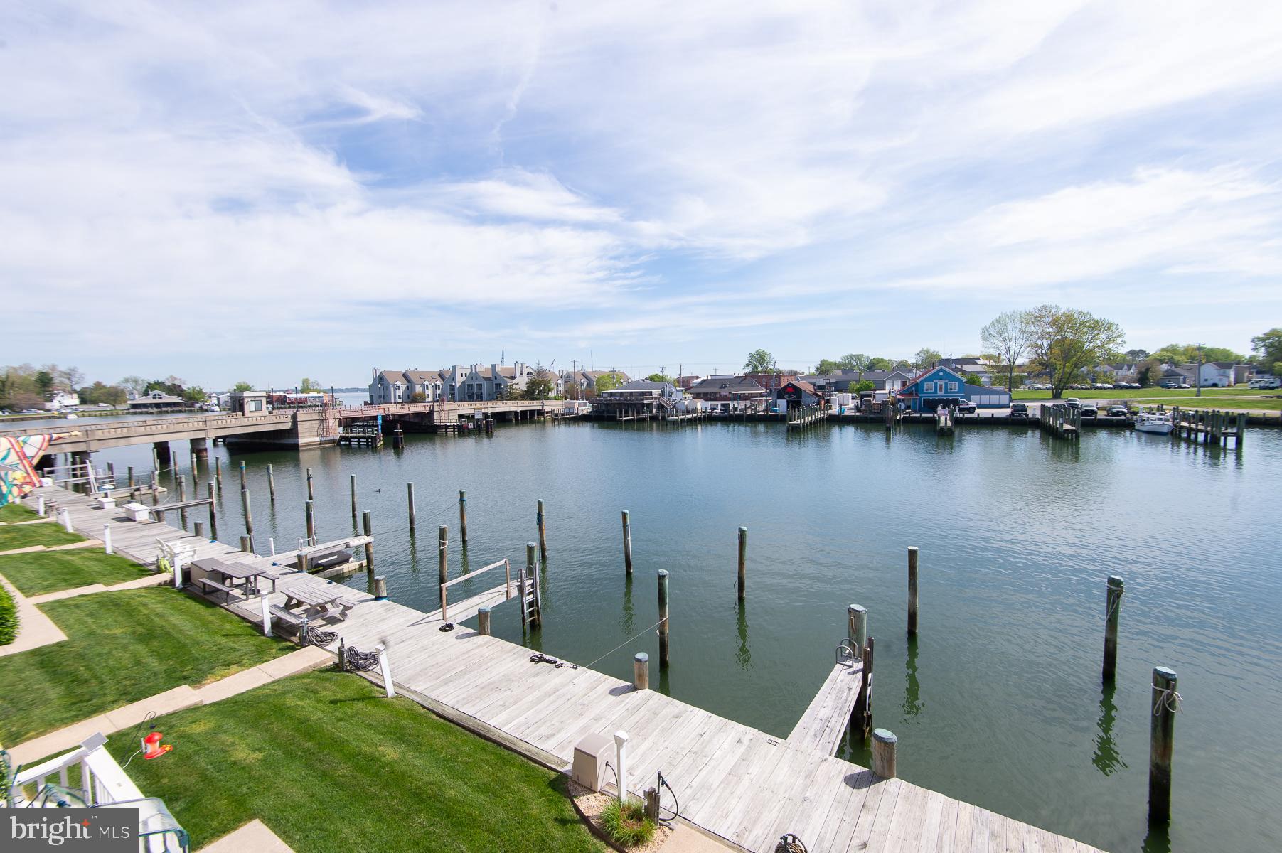 204 Market Square, Unit 12C Cambridge, MD 21613 - Photo 37 of 44 a view of a lake with lawn chairs and a lake view