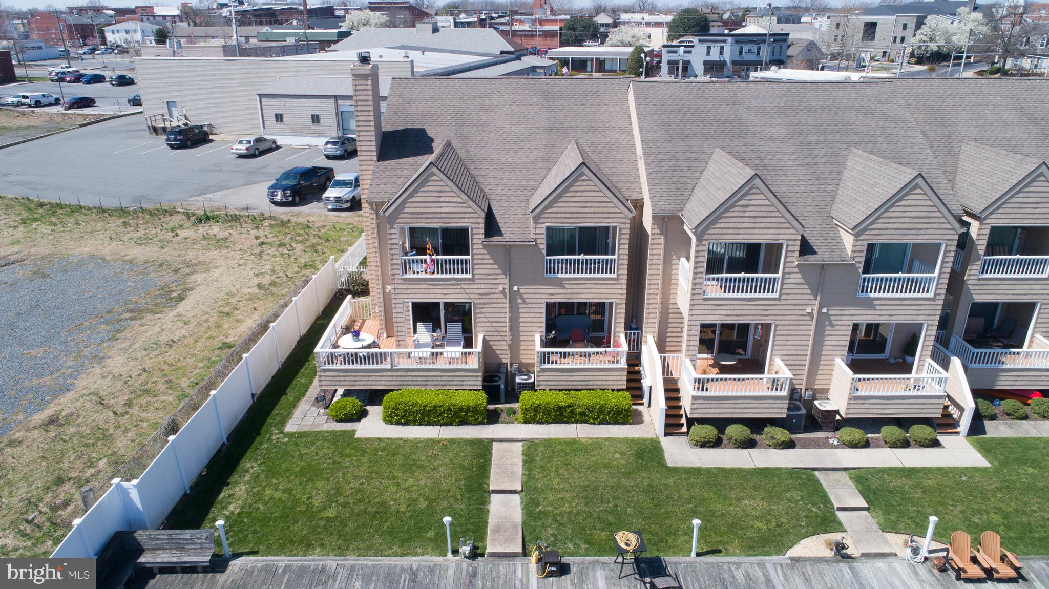 204 Market Square, Unit 12C Cambridge, MD 21613 - Photo 6 of 44 a aerial view of a house with swimming pool lawn chairs and yard