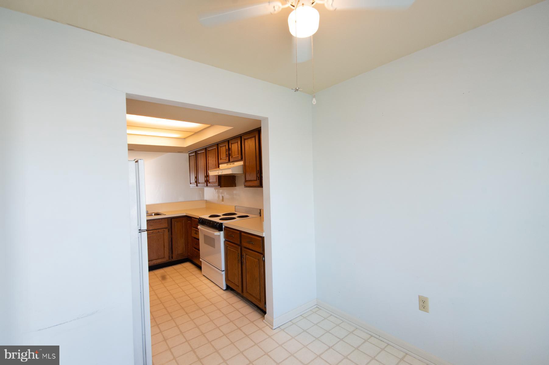 204 Market Square, Unit 12C Cambridge, MD 21613 - Photo 9 of 44 a kitchen with granite countertop a sink and stainless steel appliances