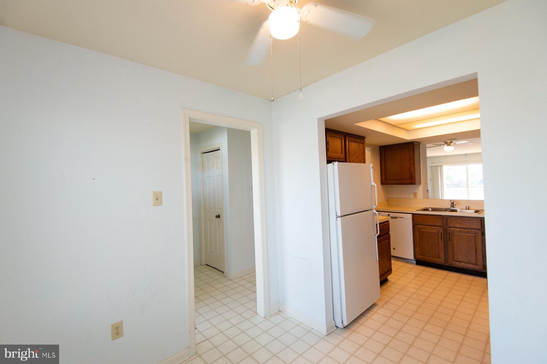 204 Market Square, Unit 12C Cambridge, MD 21613 - Photo 10 of 44 a view of a kitchen with a refrigerator a stove top oven and a refrigerator