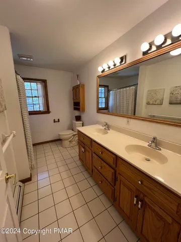 a spacious bathroom with a sink a mirror and a bathtub