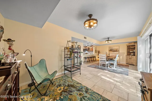 a dining room with furniture and a rug