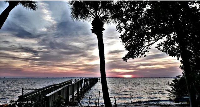 a kitchen with stainless steel appliances granite countertop a sink and a refrigerator