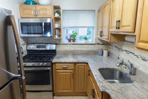 a kitchen with a sink stove and cabinets