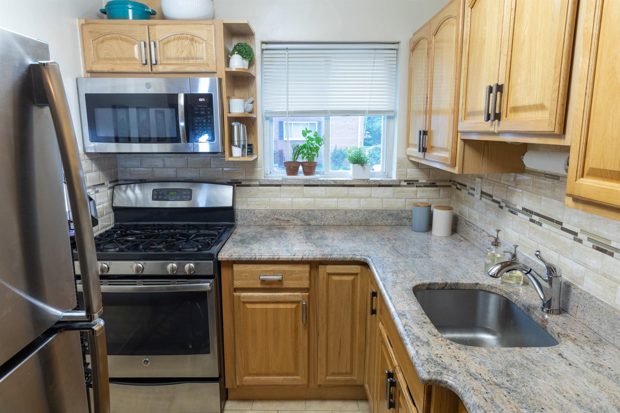 304 Fenimore Road, Unit 7A Mamaroneck, NY 10543 - Photo 5 of 10 a kitchen with a sink stove and cabinets