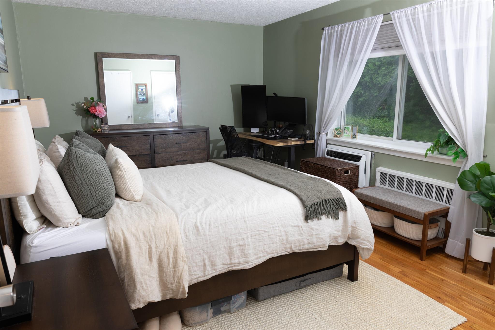 304 Fenimore Road, Unit 7A Mamaroneck, NY 10543 - Photo 7 of 10 a bedroom with a bed and a flat tv screen on dresser