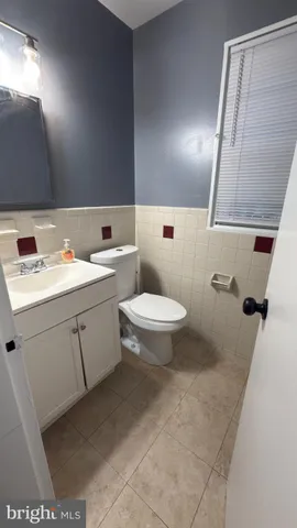 a bathroom with a sink a toilet and mirror