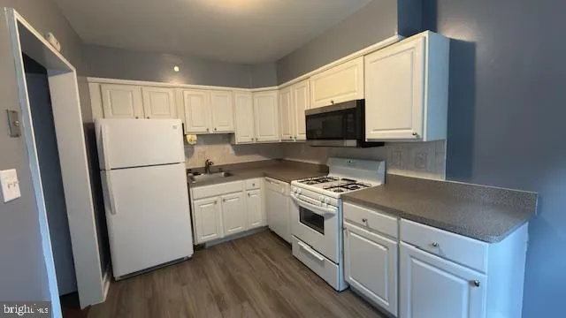 a kitchen with a refrigerator stove and sink