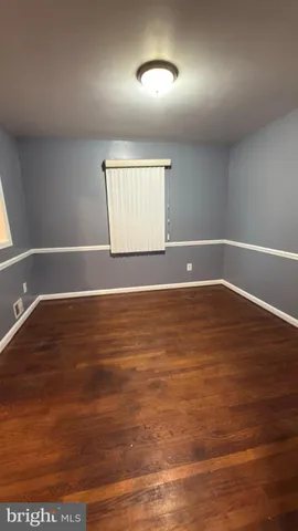 a view of room with wooden floor