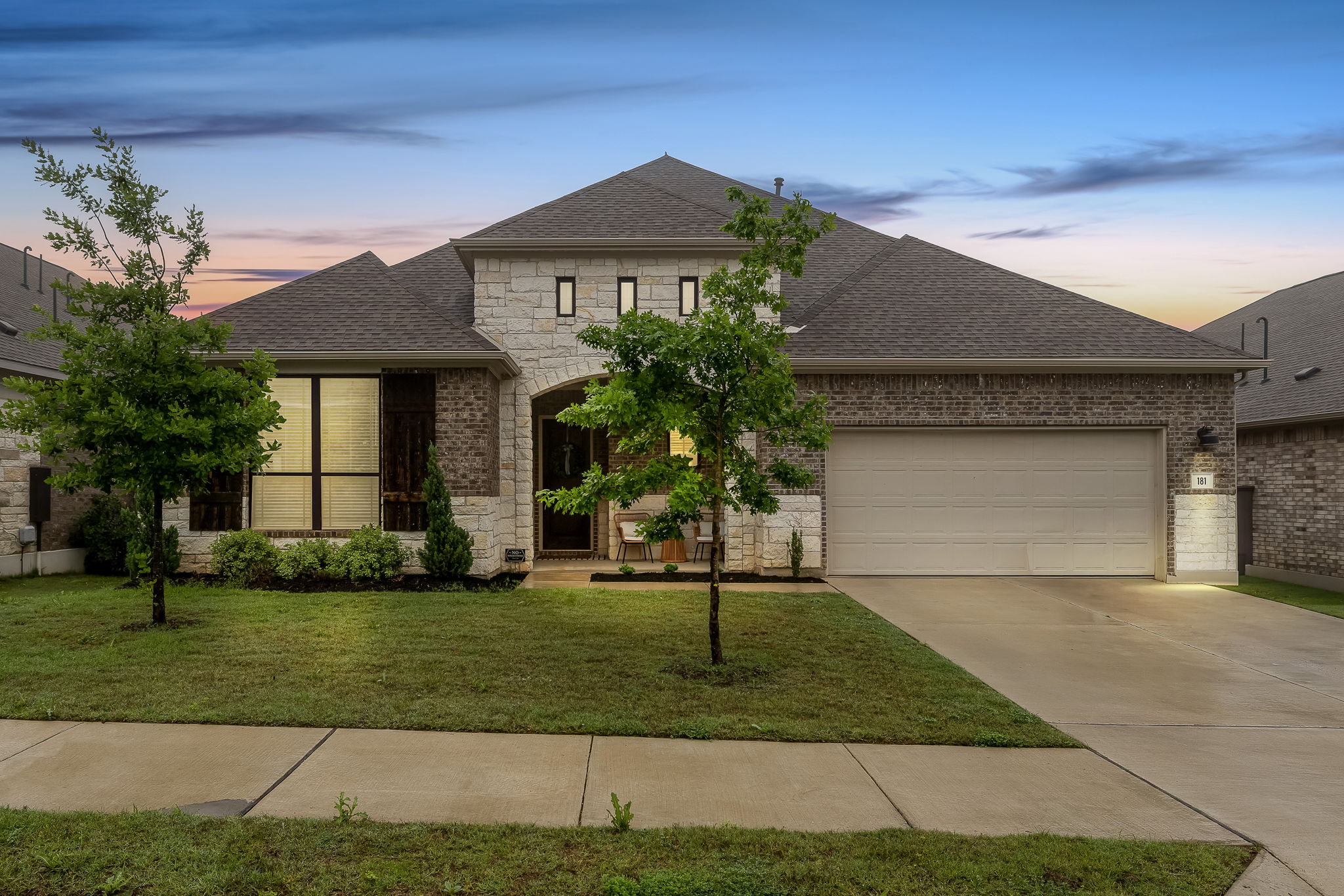 181 Constitution Way Kyle, TX 78640 - Photo 2 of 32 a front view of a house with a yard