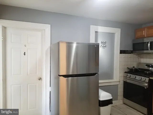 a metallic refrigerator freezer sitting in a kitchen