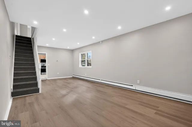 an empty room with a hallway and a window