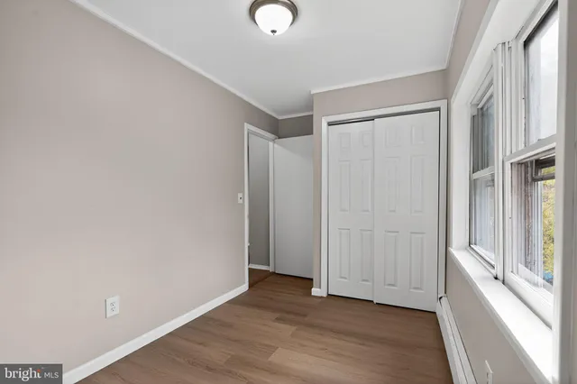 a view of an empty room with wooden floor