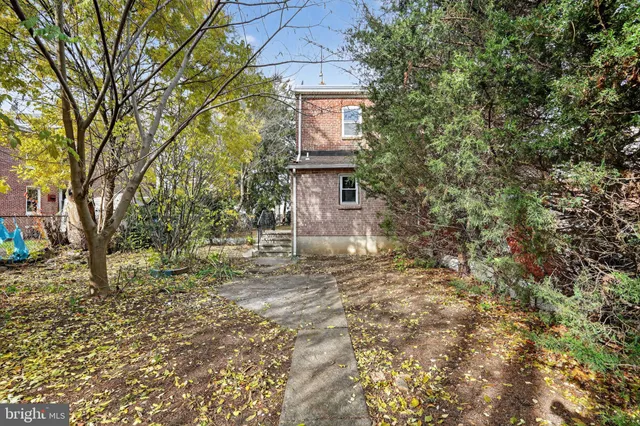 a brick building with large trees