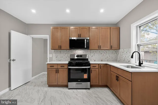 a kitchen with a sink and a stove top oven