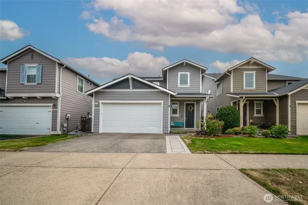 a front view of a house with a yard and garage