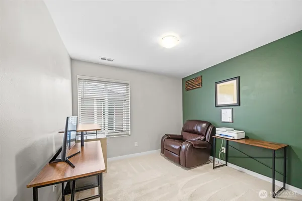a living room with furniture a rug and a window