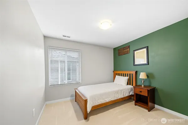 a bedroom with a bed table and window