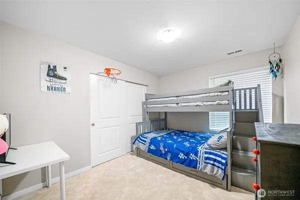 a bedroom with furniture and wooden floor