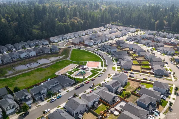 an aerial view of a houses with a yard