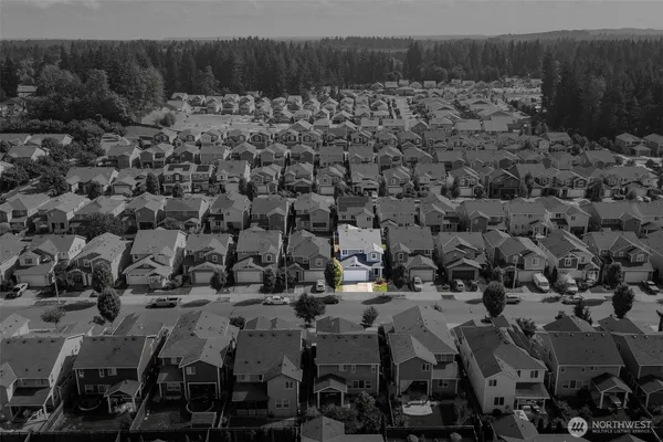 an aerial view of a house with a yard