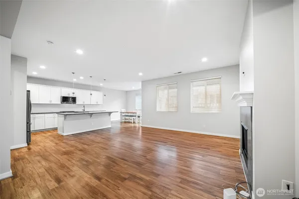 a view of kitchen with wooden floor and electronic appliances