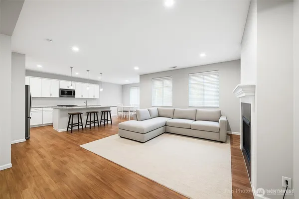 a living room with stainless steel appliances kitchen island granite countertop furniture and a kitchen view