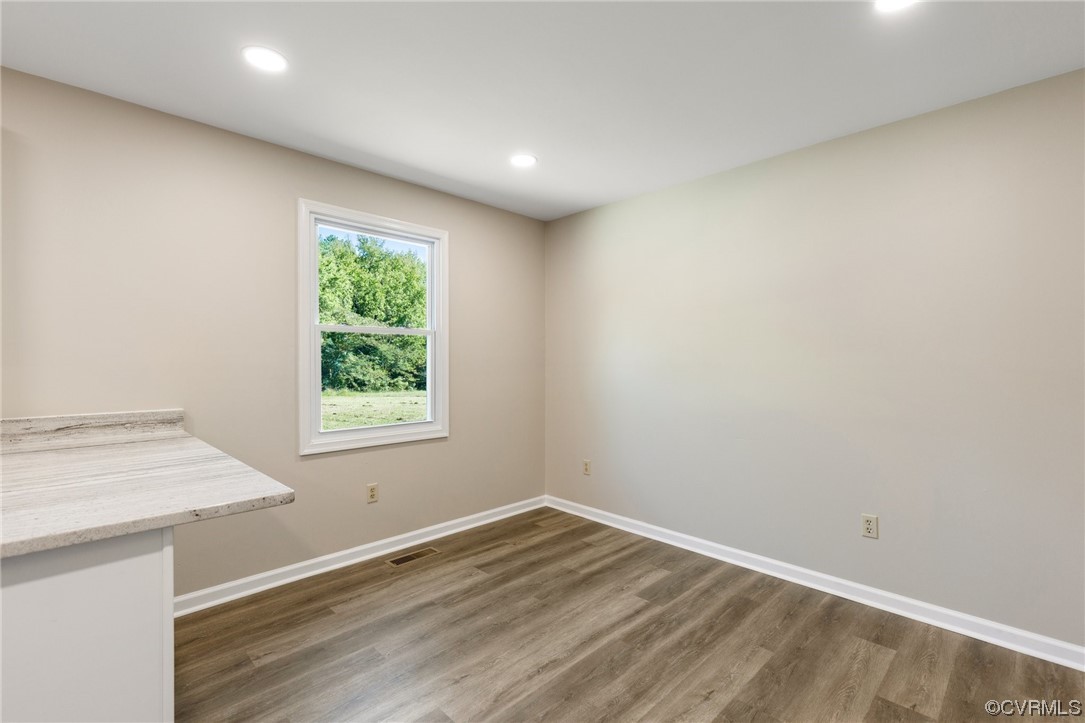 4807 Olgers Road Sutherland, VA 23885 - Photo 13 of 25 an empty room with wooden floor and a window
