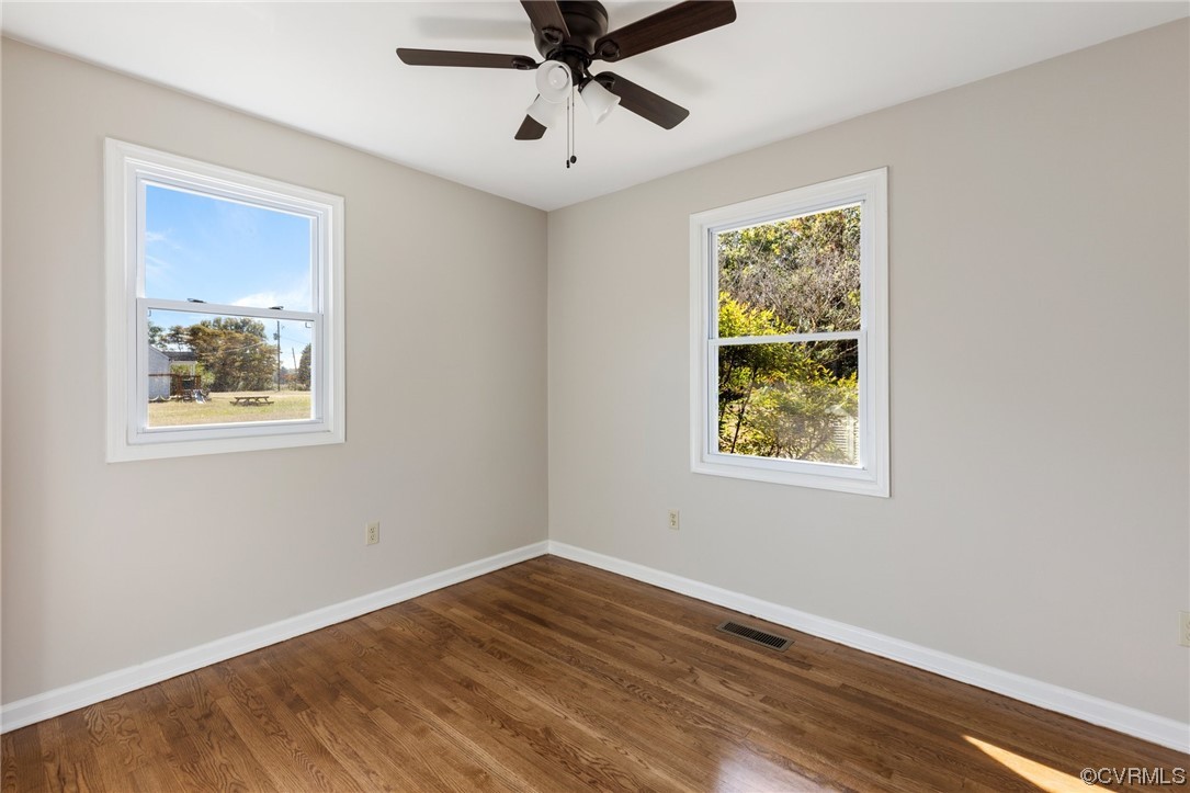 4807 Olgers Road Sutherland, VA 23885 - Photo 18 of 25 a view of an empty room with wooden floor and a window