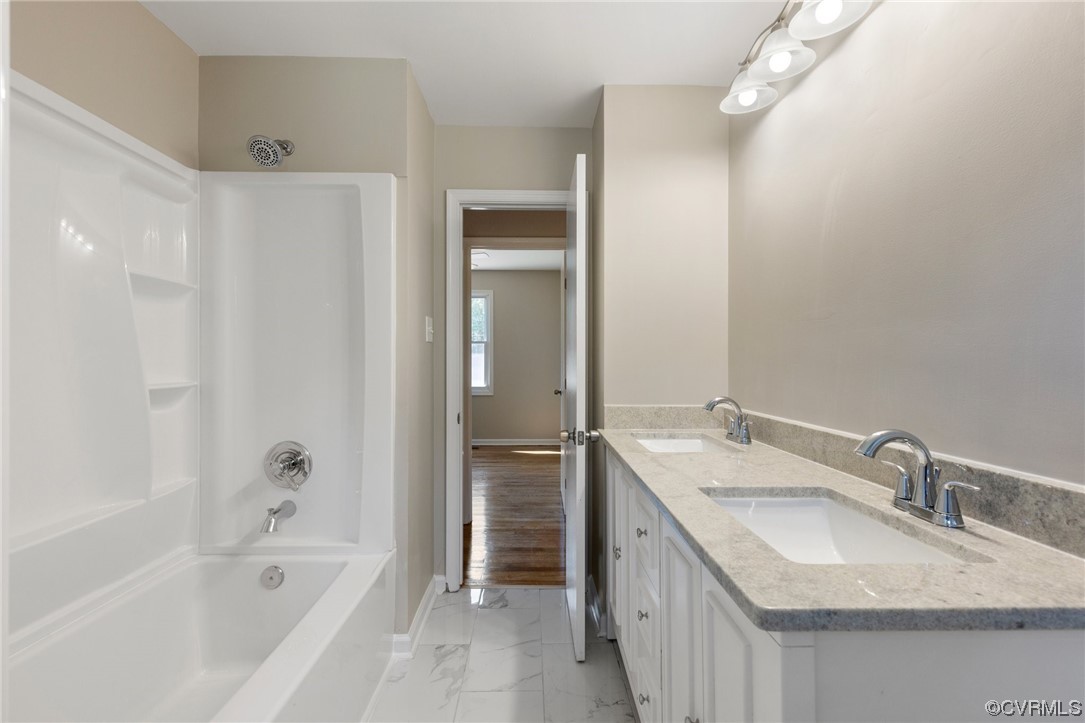4807 Olgers Road Sutherland, VA 23885 - Photo 19 of 25 a bathroom with a granite countertop tub sink and mirror