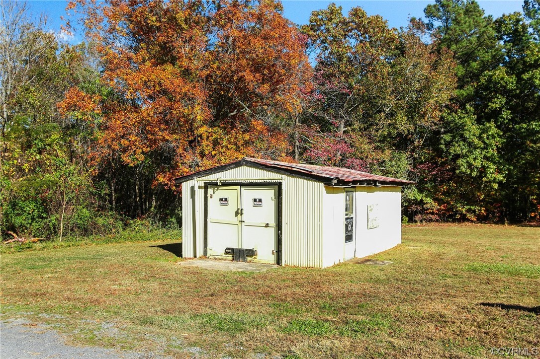 4807 Olgers Road Sutherland, VA 23885 - Photo 23 of 25 a house with trees in front of it