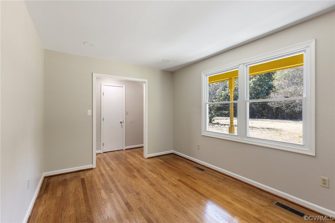 4807 Olgers Road Sutherland, VA 23885 - Photo 6 of 25 an empty room with wooden floor and windows
