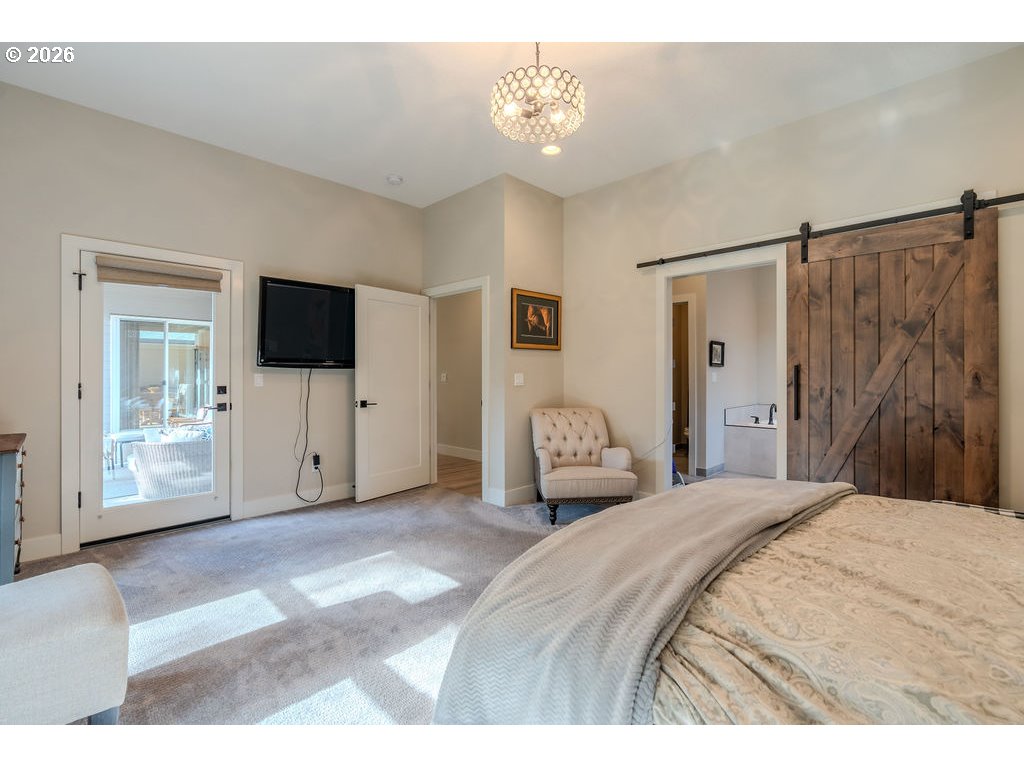 38408 Juniper Street Sandy, OR 97055 - Photo 17 of 47 a spacious bedroom with a bed and a flat screen tv