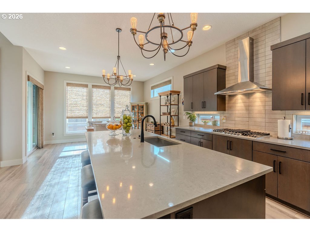 38408 Juniper Street Sandy, OR 97055 - Photo 23 of 47 a kitchen with stainless steel appliances granite countertop a sink dishwasher a microwave oven with a dining table and chairs
