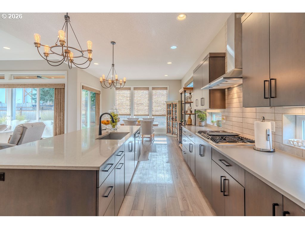 38408 Juniper Street Sandy, OR 97055 - Photo 25 of 47 a kitchen with kitchen island granite countertop a sink stove and wooden cabinets