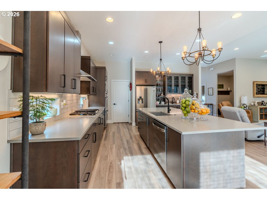 38408 Juniper Street Sandy, OR 97055 - Photo 31 of 47 a kitchen with kitchen island granite countertop a sink cabinets and stainless steel appliances