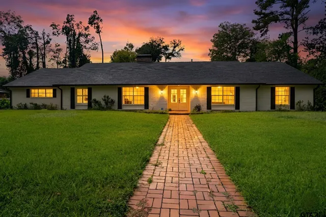 a view of a brick house with a yard