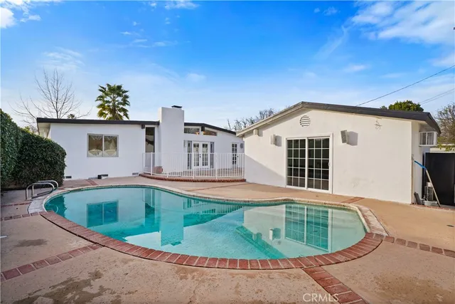 a living room with lots of furniture and white walls
