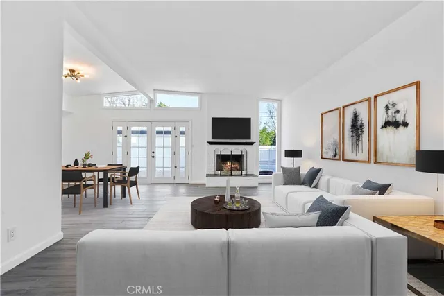 a living room with furniture a fireplace and a flat screen tv
